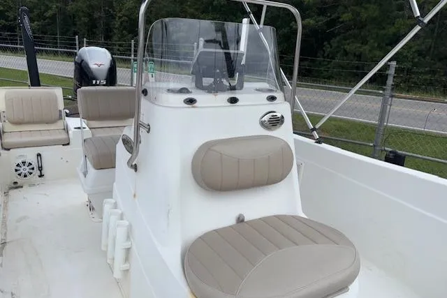 Slide: The Image of 2011 NauticStar 210 Coastal boat interior with beige seating and console. - 15