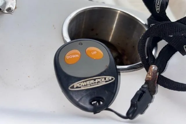 Slide: The Image of Remote control for Power-Pole on 2011 NauticStar 210 Coastal boat, near cup holder. - 17