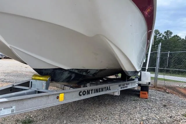 Slide: The Image of 2011 NauticStar 210 Coastal boat on Continental trailer, parked on gravel. - 24