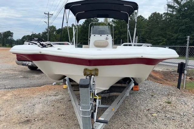 Slide: The Image of 2011 NauticStar 210 Coastal boat on trailer, parked outdoors with canopy. - 3