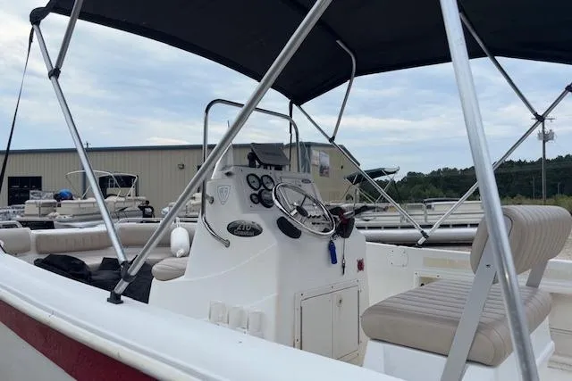 Slide: The Image of 2011 NauticStar 210 Coastal boat interior with steering console and seating. - 5