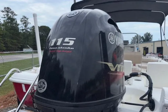 Slide: The Image of 2011 NauticStar 210 Coastal boat with Yamaha 115 four-stroke engine, outdoor setting. - 7