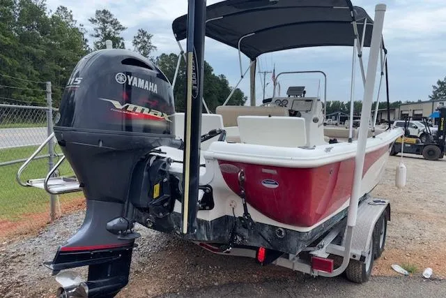 Slide: The Image of 2011 NauticStar 210 Coastal boat with Yamaha motor on trailer, parked outdoors. - 8