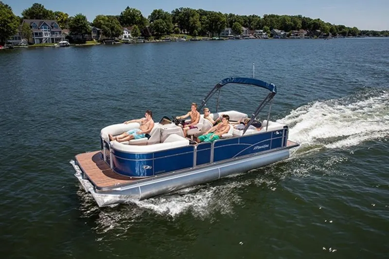 Slide: The Image of 2018 Manitou 23 Aurora LE RF pontoon boat cruising on a lake with passengers. - 14