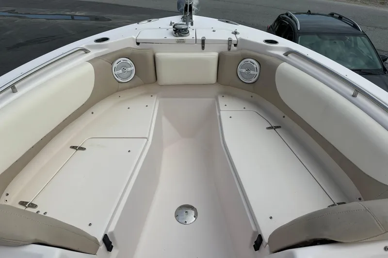 Slide: The Image of 2012 Grady-White Freedom 275 boat interior with cushioned seating and speakers. - 10