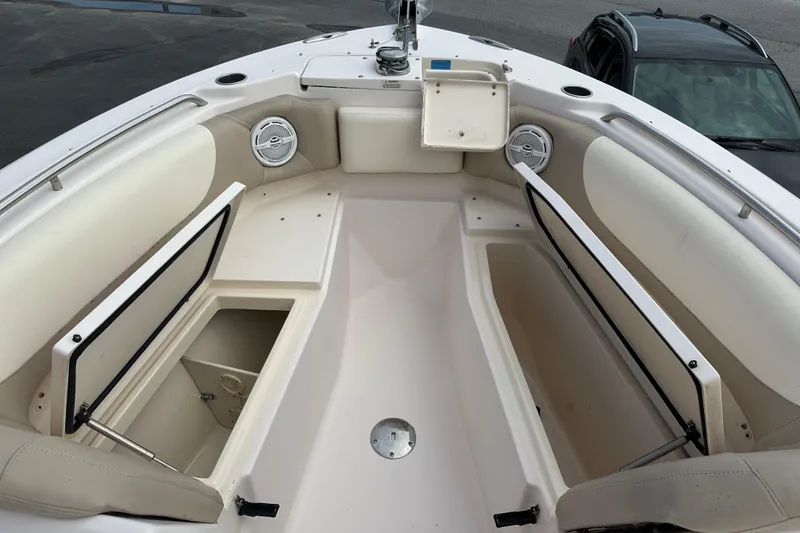 Slide: The Image of 2012 Grady-White Freedom 275 boat interior with open storage compartments and seating. - 11