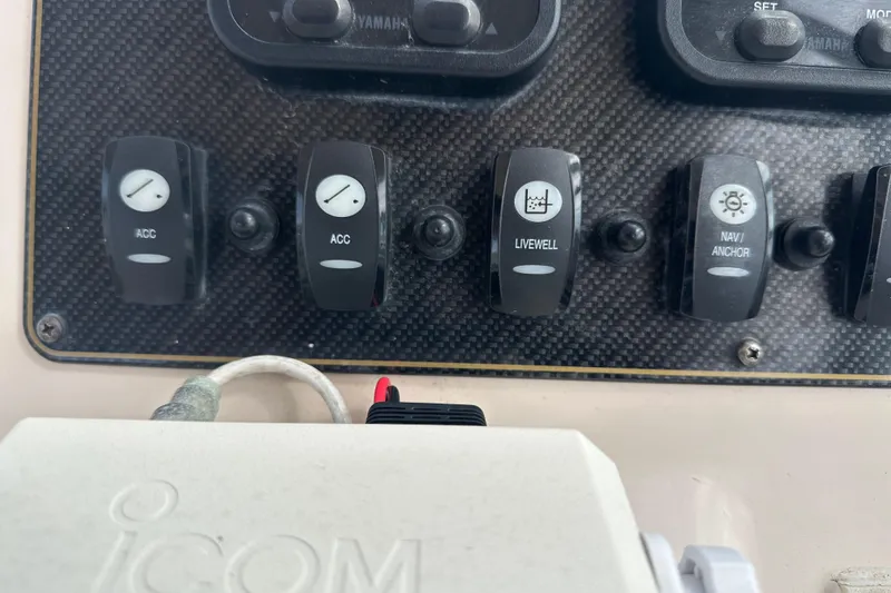Slide: The Image of Control panel of a 2012 Grady-White Freedom 275 boat with switches and Icom device. - 22