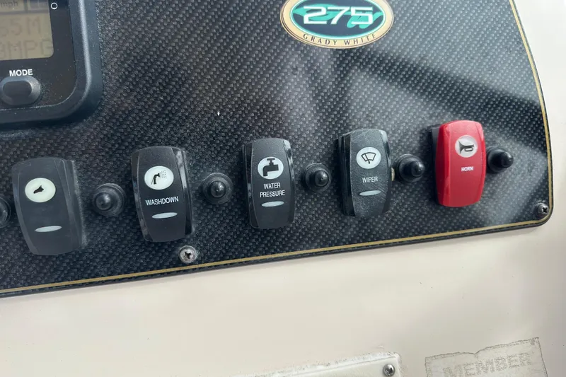 Slide: The Image of Control panel of 2012 Grady-White Freedom 275 boat with labeled switches. - 24