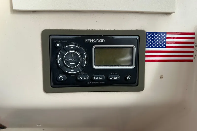Slide: The Image of Kenwood stereo system on 2012 Grady-White Freedom 275 boat with American flag decal. - 27