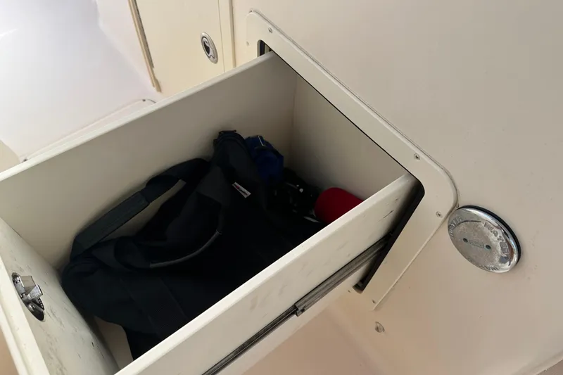 Slide: The Image of Storage compartment on a 2012 Grady-White Freedom 275 boat with bag inside. - 29