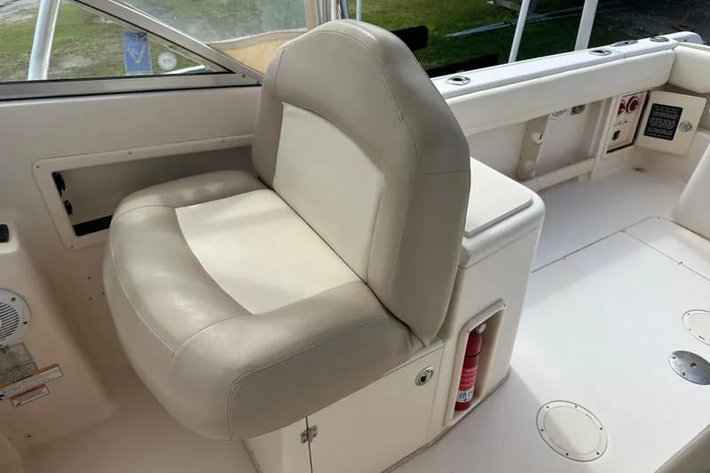 Slide: The Image of 2012 Grady-White Freedom 275 boat interior with beige seating and storage compartments. - 30