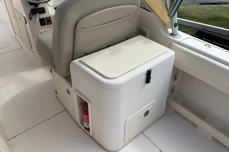 Slide: The Image of 2012 Grady-White Freedom 275 boat interior with seat and storage compartment. - 32