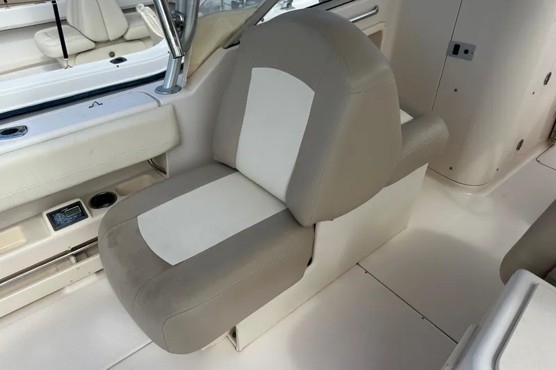 Slide: The Image of 2012 Grady-White Freedom 275 boat seat, beige and white upholstery, interior view. - 34