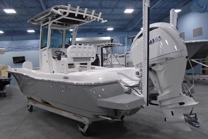 The Image of 2026 Caymas 24 HB boat with Yamaha engine in showroom setting. - 0