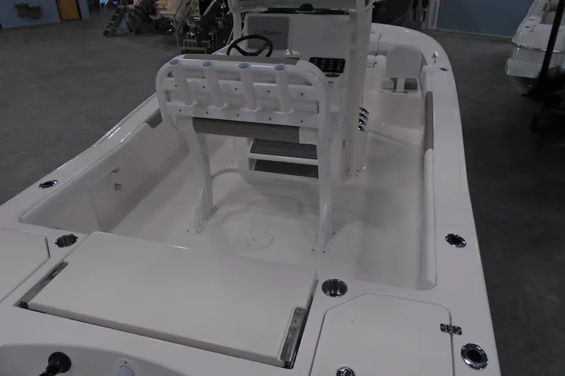 Slide: The Image of 2026 Caymas 24 HB boat interior with console and seating, showcasing modern design. - 10