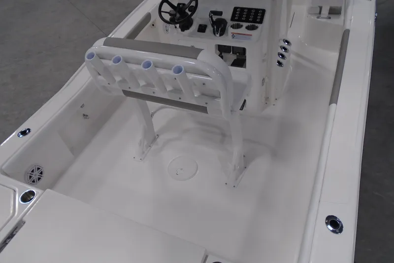 Slide: The Image of 2026 Caymas 24 HB boat interior with steering console and rod holders. - 12