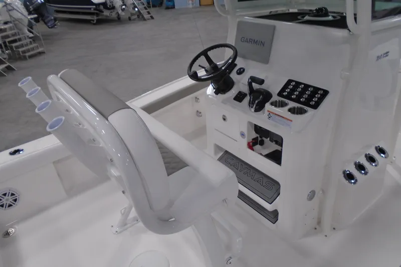 Slide: The Image of 2026 Caymas 24 HB boat interior with Garmin navigation and rod holders. - 13
