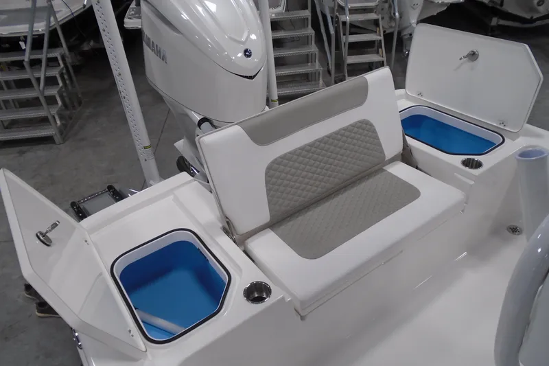 Slide: The Image of 2026 Caymas 24 HB boat interior with cushioned seating and storage compartments. - 20