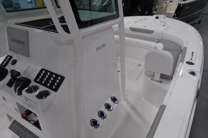 Slide: The Image of 2026 Caymas 24 HB boat interior with Garmin electronics and seating area. - 22