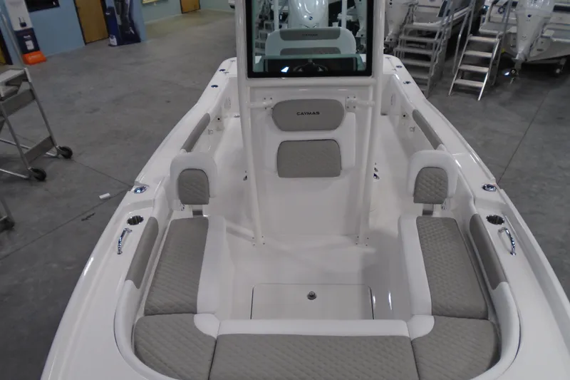 Slide: The Image of 2026 Caymas 24 HB boat interior with gray seating and modern design. - 26