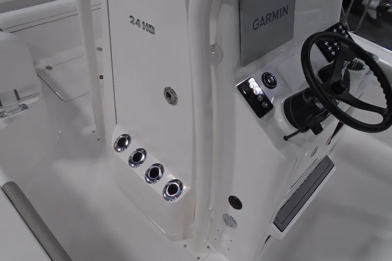 Slide: The Image of 2026 Caymas 24 HB boat console with Garmin display and steering wheel. - 30