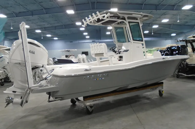 Slide: The Image of 2026 Caymas 24 HB boat in showroom, featuring Yamaha outboard motor. - 4