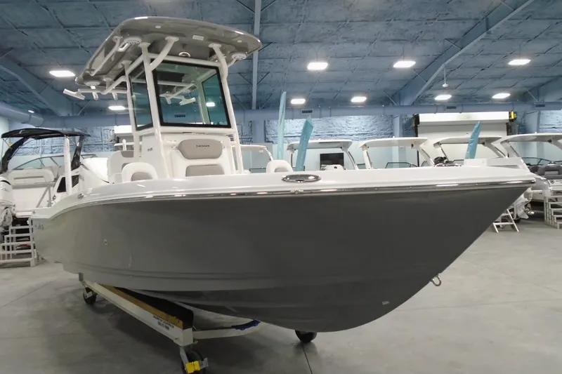 Slide: The Image of 2026 Caymas 24 HB boat displayed in a showroom, featuring sleek design and modern amenities. - 5