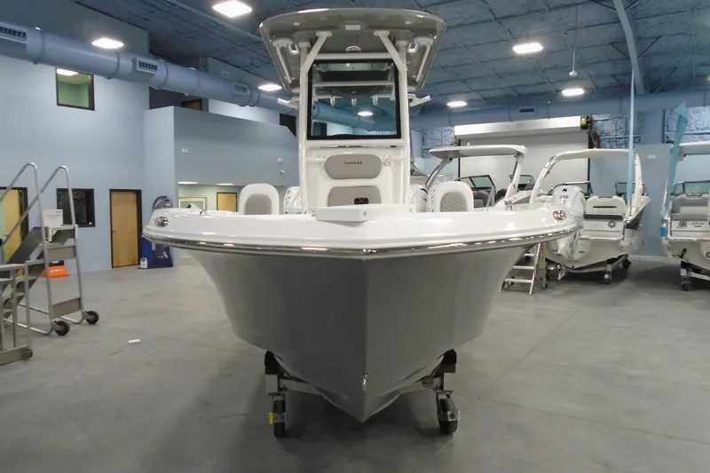 Slide: The Image of 2026 Caymas 24 HB boat displayed in a showroom with modern interior. - 6