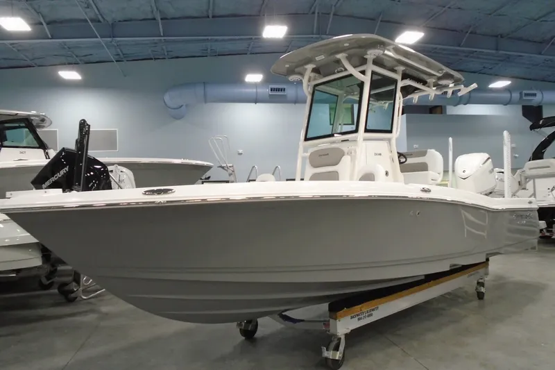 Slide: The Image of 2026 Caymas 24 HB boat in showroom, featuring sleek design and modern features. - 7