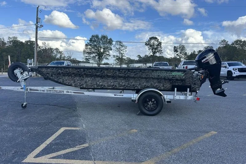 The Image of 2025 Havoc 1756 boat on trailer with Mercury outboard motor, parked outdoors. - 1