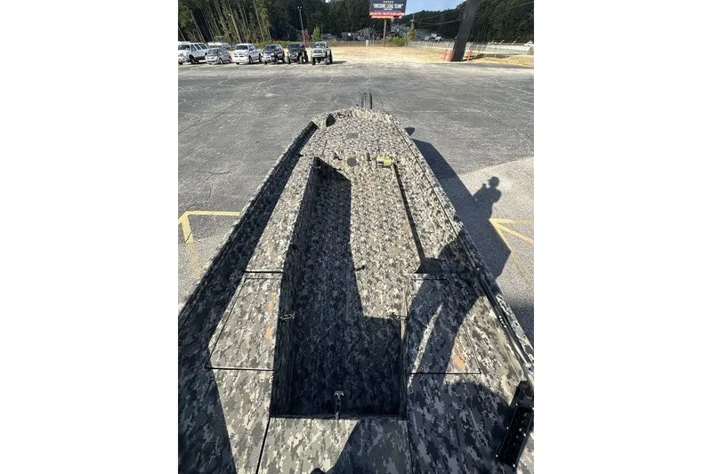 Slide: The Image of Camouflage-patterned 2025 Havoc 1756 boat parked in a lot, surrounded by vehicles. - 5