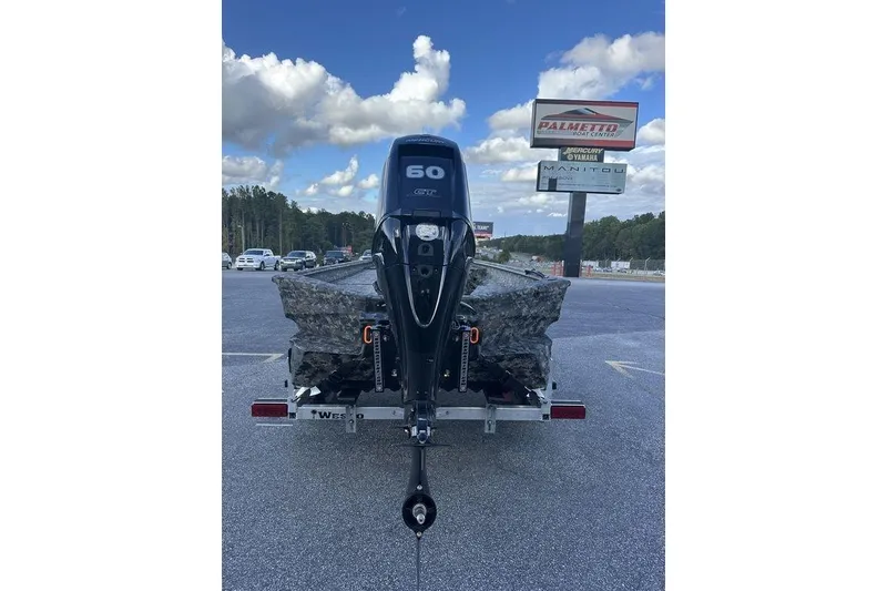 Slide: The Image of 2025 Havoc 1756 boat with 60 HP engine on trailer, parked outdoors. - 6