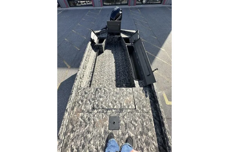 Slide: The Image of 2025 Havoc 1756 boat with camo deck, open storage compartments, and visible motor. - 8