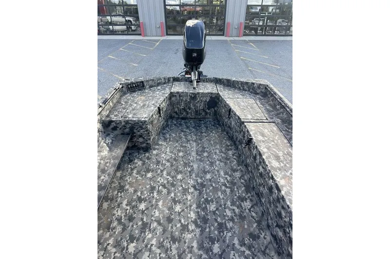 Slide: The Image of 2025 Havoc 1756 boat with digital camouflage interior and outboard motor. - 9