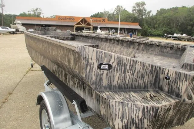 Slide: The Image of 2026 Reaper Boats 653-1690 with camouflage design on trailer at dockside marine. - 7