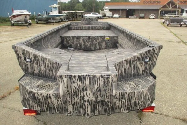 Slide: The Image of Reaper Boats 653-1690, 2026 model, camo design, dockside view, spacious interior. - 8