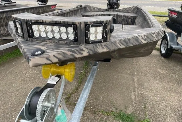 Slide: The Image of 2026 Reaper Boats 653-1690 with camouflage design and LED lights on trailer. - 9