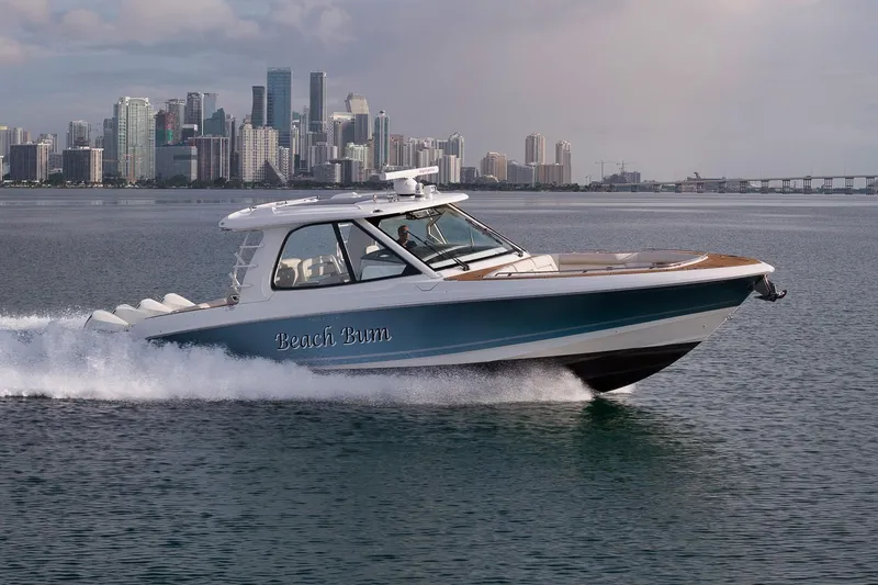The Image of 2020 Boston Whaler 380 Realm cruising near city skyline on calm water. - 0