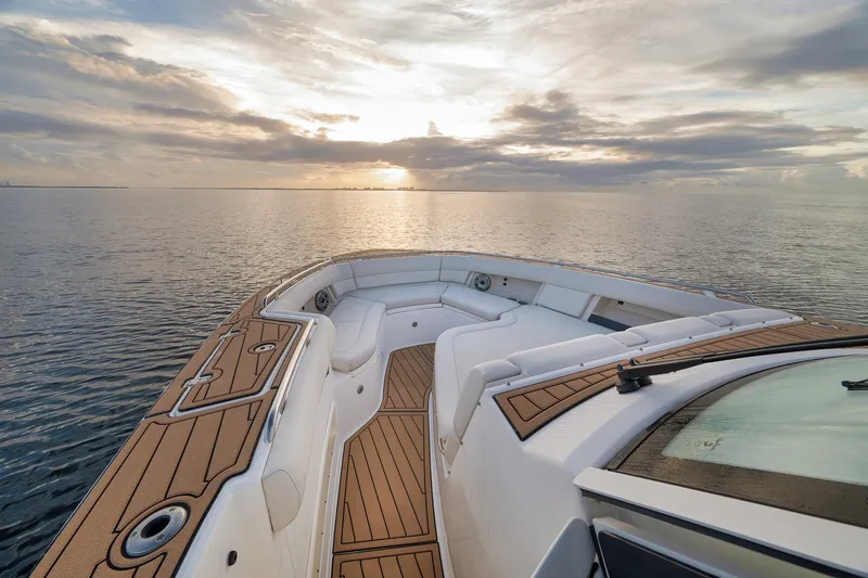 Slide: The Image of 2020 Boston Whaler 380 Realm boat at sunset on calm waters. - 11