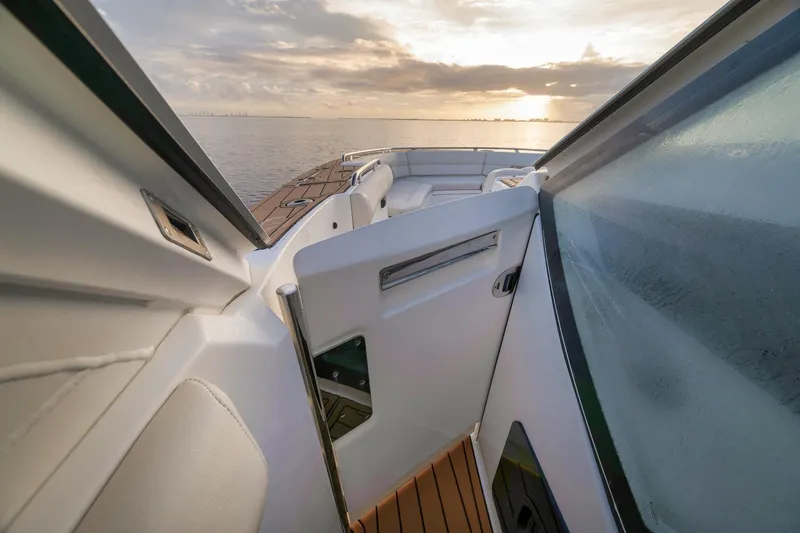 Slide: The Image of 2020 Boston Whaler 380 Realm boat interior with ocean view at sunset. - 13