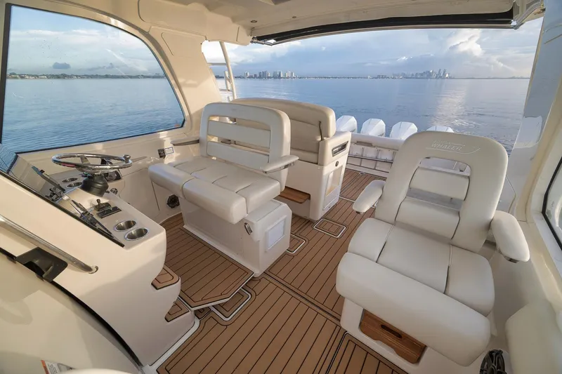 Slide: The Image of 2020 Boston Whaler 380 Realm interior with luxurious seating and ocean view. - 14