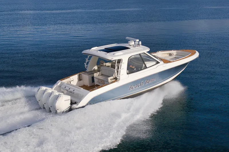 Slide: The Image of 2020 Boston Whaler 380 Realm cruising on open water, showcasing sleek design and powerful engines. - 2