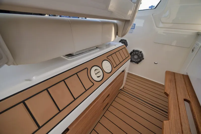 Slide: The Image of Interior of 2020 Boston Whaler 380 Realm with teak flooring and cushioned seating. - 23