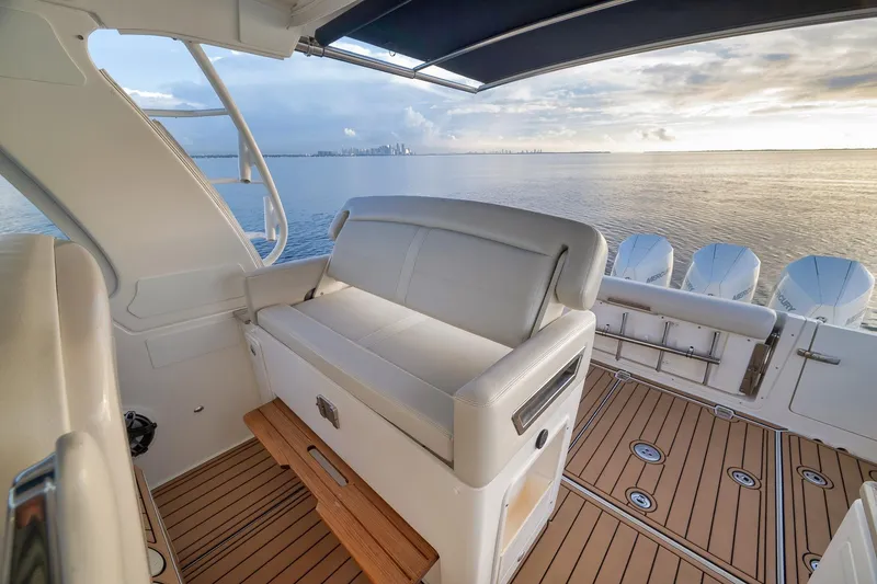 Slide: The Image of 2020 Boston Whaler 380 Realm interior with ocean view, featuring comfortable seating and multiple engines. - 24