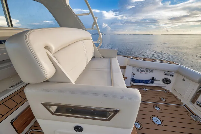 Slide: The Image of Luxury seating on 2020 Boston Whaler 380 Realm boat, overlooking serene ocean view. - 25