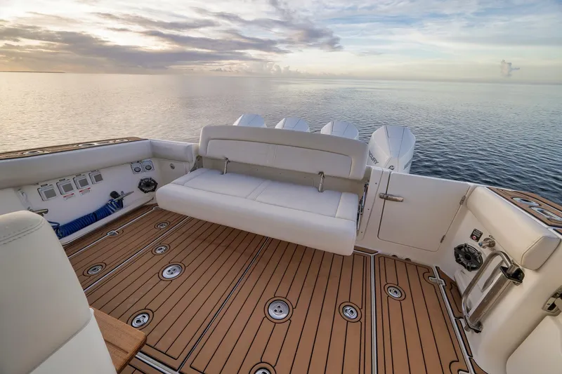 Slide: The Image of 2020 Boston Whaler 380 Realm boat interior with seating, ocean view, and sunset. - 30