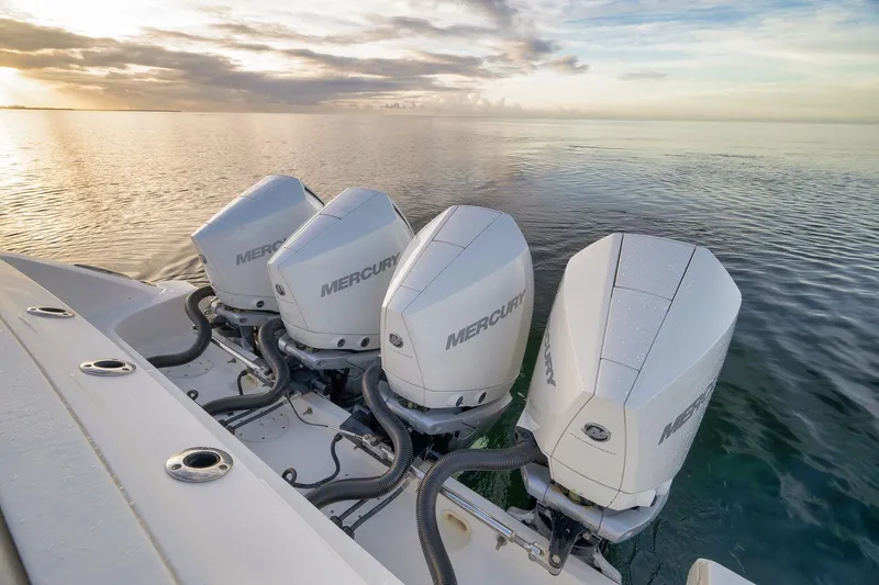 Slide: The Image of Four Mercury outboard engines on a 2020 Boston Whaler 380 Realm at sunrise. - 35