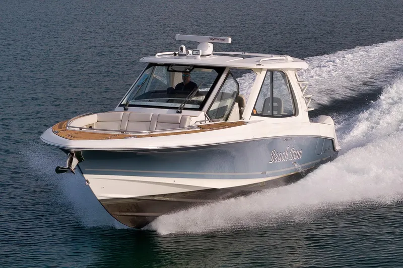 Slide: The Image of 2020 Boston Whaler 380 Realm cruising on water, showcasing sleek design and powerful performance. - 4