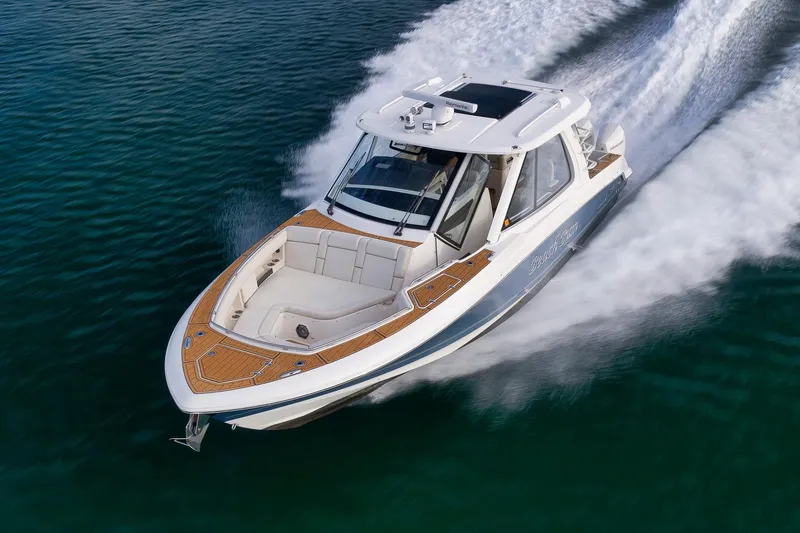 Slide: The Image of 2020 Boston Whaler 380 Realm cruising swiftly on open water. - 5