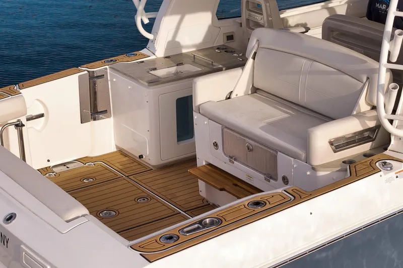 Slide: The Image of 2020 Boston Whaler 380 Realm boat interior with seating and teak flooring. - 8